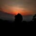 silhouette of person against sunset sky